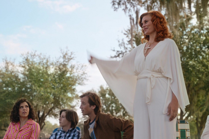 White V-neck jumpsuit with wide sleeves and tie belt of Cassidy Freeman as Amber Gemstone Outfit The Righteous Gemstones TV Show