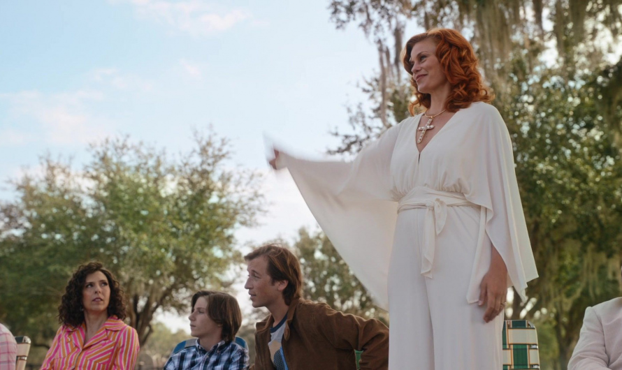 White V-neck jumpsuit with wide sleeves and tie belt of Cassidy Freeman as Amber Gemstone