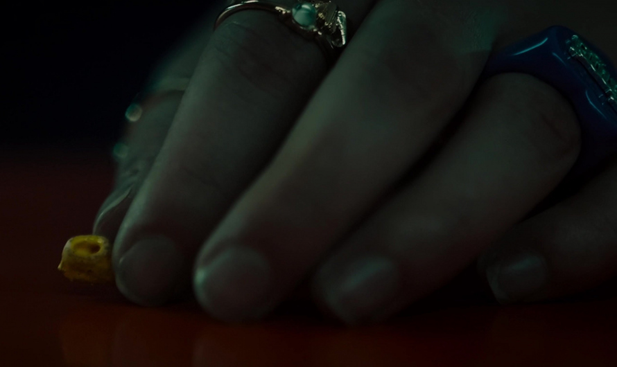 Gold Ring with a Central Turquoise-Colored Gem Worn by Lizze Broadway as Emma Meyer