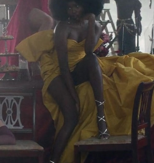 Yellow Off-Shoulder Draped Gown of Laura Kariuki as Vivian Lee Finch
