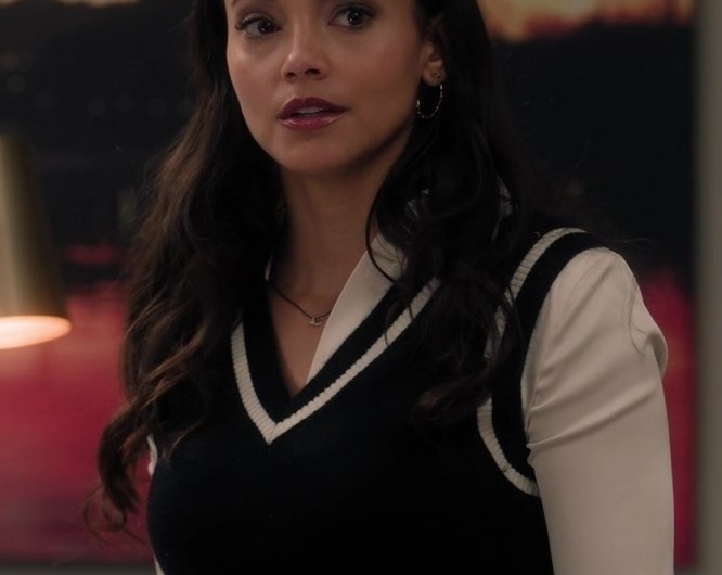 Black V-Neck Sweater Vest with White Striped Trim Worn by Gabrielle Walsh as Lacey Quinn