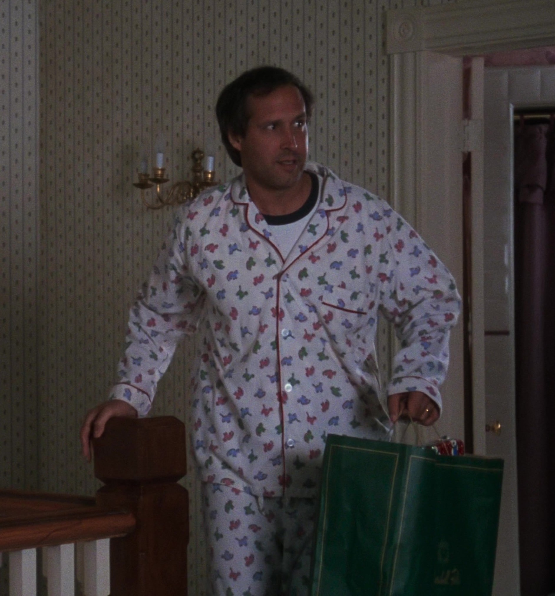 Worn on National Lampoon's Christmas Vacation (1989) Movie - Classic Button-Up Pajama Set with Festive Dinosaur Print Worn by Chevy Chase as Clark W. "Sparky" Griswold Jr.
