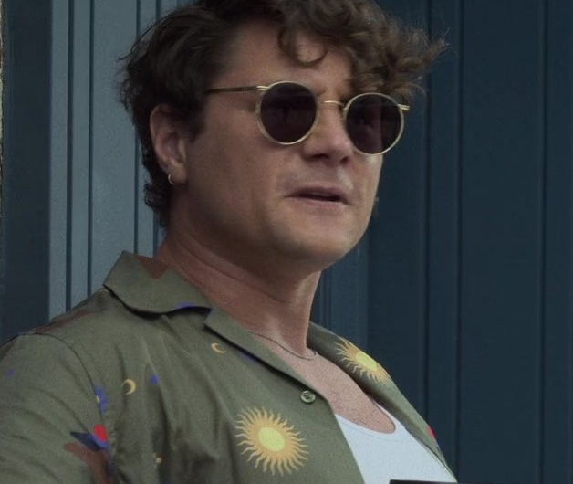 Olive Green Casual Button-Down Shirt with Unique Sun and Mountain Print Worn by Augustus Prew as Brannagan