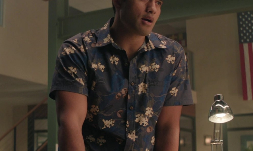 Island-Inspired Blue Button-Up Shirt with Hibiscus Flower Patterns  Worn by Alex Tarrant as Kai Holman