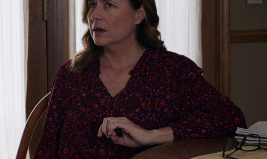 Dark Red Floral Blouse with Relaxed Fit and V-Neckline Worn by Jenna Fischer as Ms. Heron