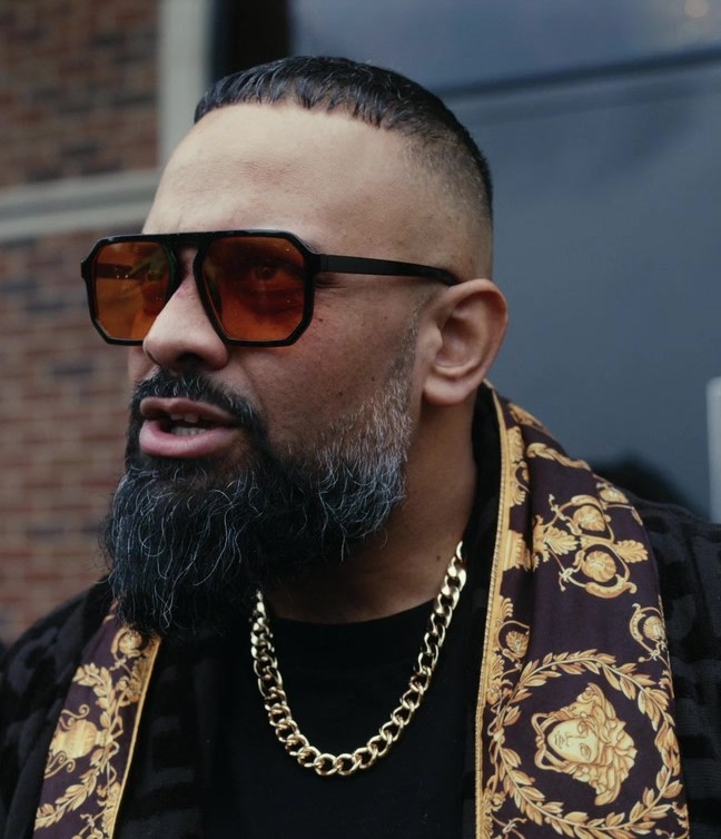 Bold Square Frame Sunglasses with Amber Tinted Lenses and Black Acetate Frame Worn by Guz Khan as Chucky