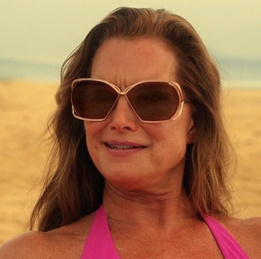 Glamorous Taupe Tinted Sunglasses with Broad Frames of Brooke Shields as Lana