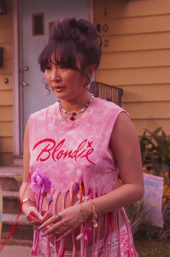 vibrant pink tie-dye top with fringe and blondie graphic - Poppy Liu (Nadine Cai) - Space Cadet (2024) Movie